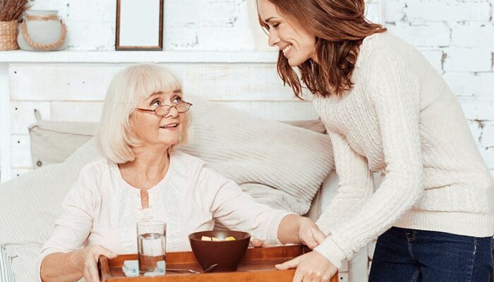 Caregiver assisting an elderly lady